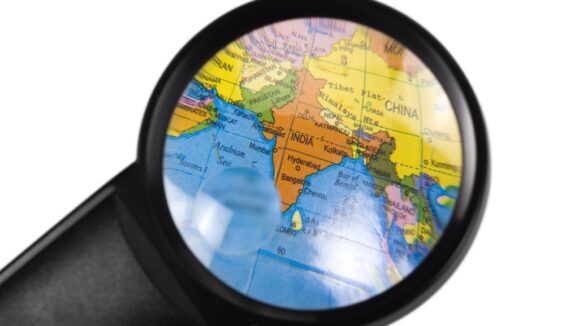India on globe viewed through a magnifying glass
