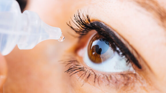 Macro,Pose,Of,Woman,Dripping,Eye,With,Eyes,Drops