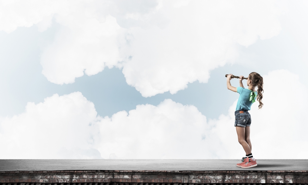 Cute kid girl standing on house roof and looking in spyglass