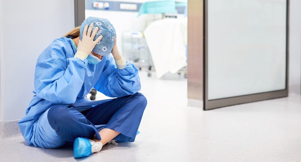 Exhausted,Doctor,Or,Nurse,Sits,In,Front,Of,The,Operating