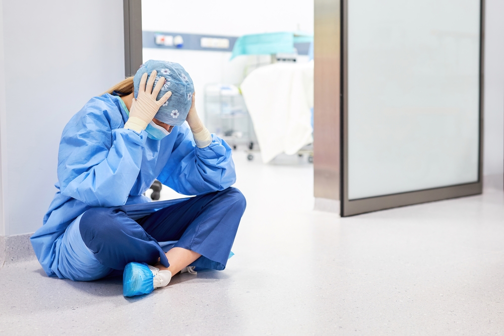 Exhausted,Doctor,Or,Nurse,Sits,In,Front,Of,The,Operating