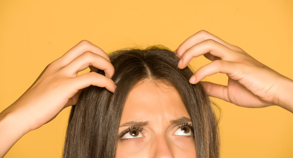 Beautiful,Young,Woman,With,Itchy,Scalp,On,Yellow,Background