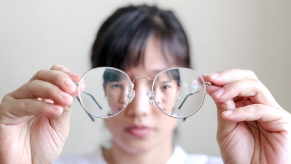 Short sighted,Woman,Is,Holding,Glasses,In,Hand,With,White,Background.