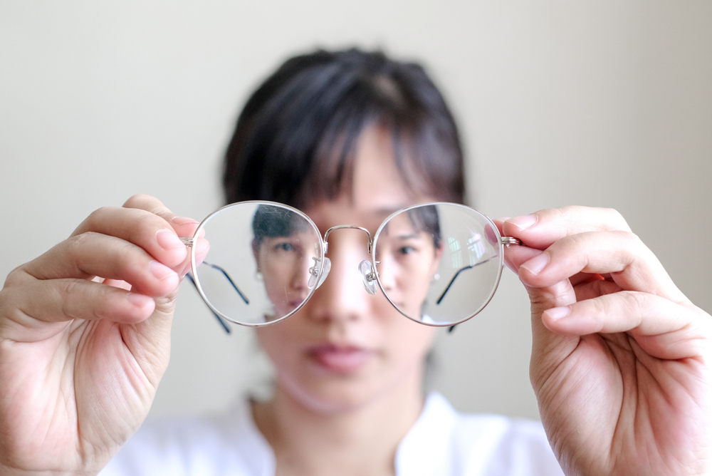 Short sighted,Woman,Is,Holding,Glasses,In,Hand,With,White,Background.