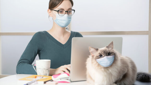 A,Young,Woman,In,A,Medical,Mask,Works,On,A